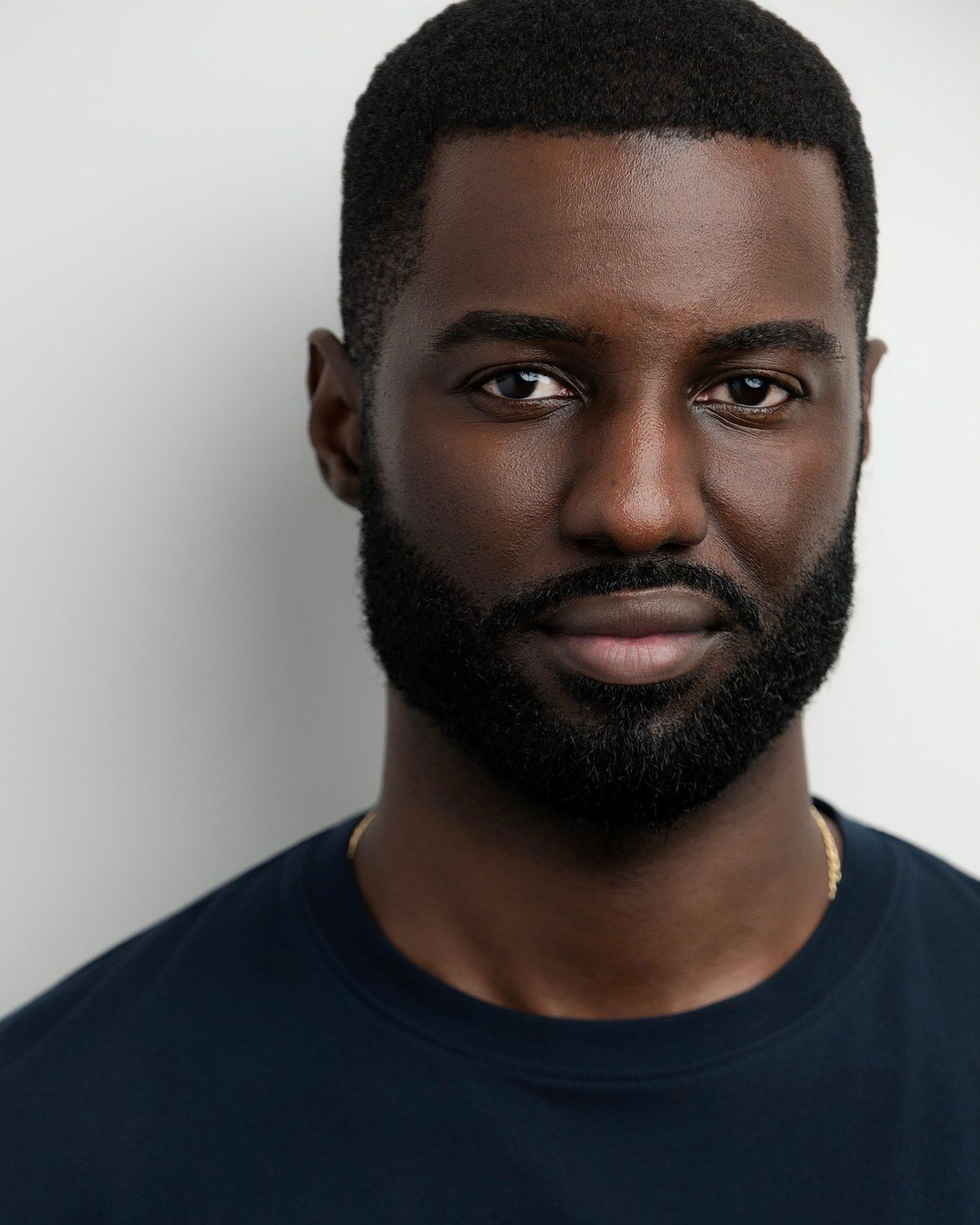Marcus R. Smith headshot, navy t-shirt on a white background